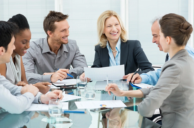 Smiling employees who are covered by a group health insurance plan in Fort Mill, SC